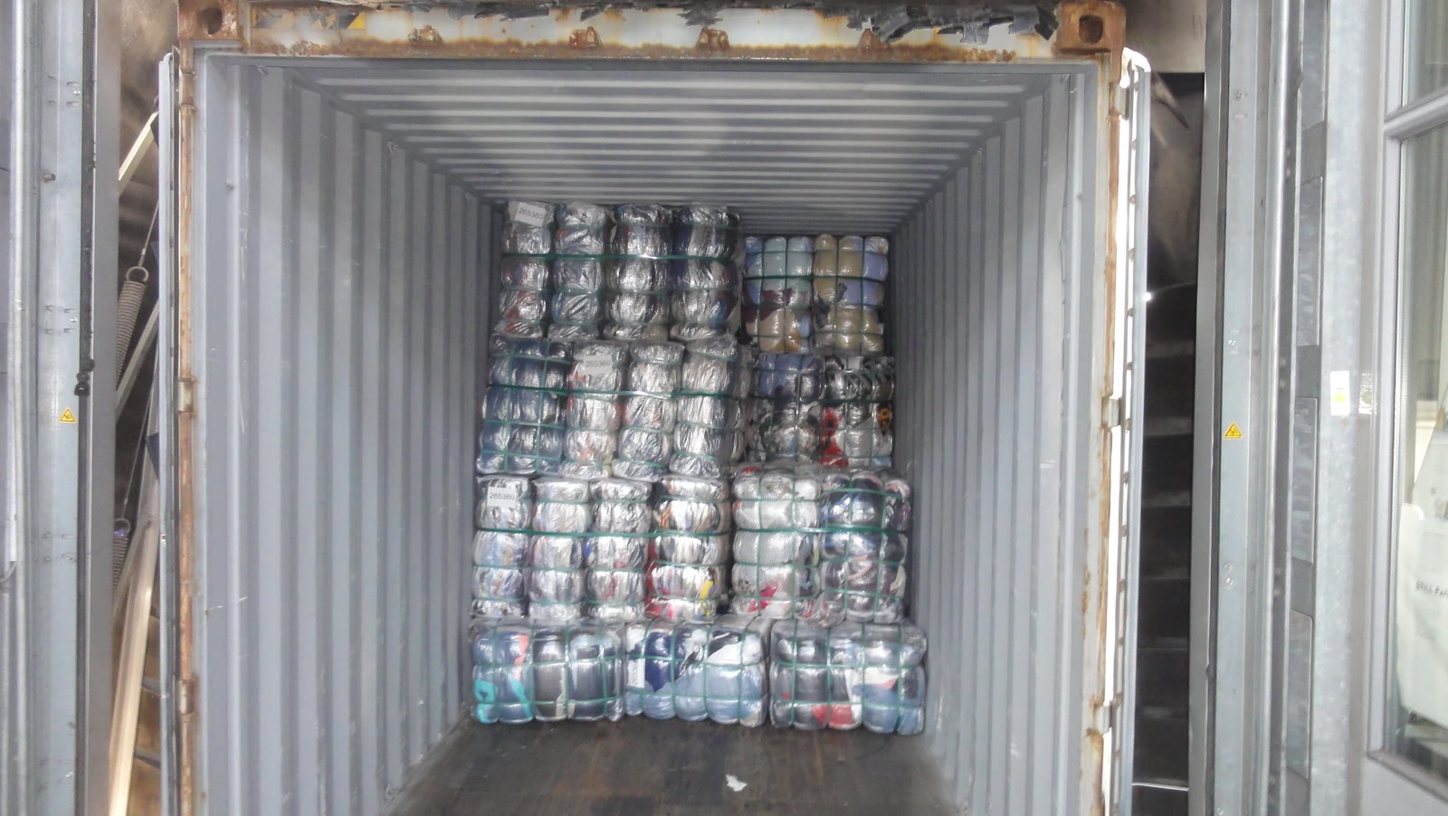 Wrapped bales loaded into a shipping container for transport