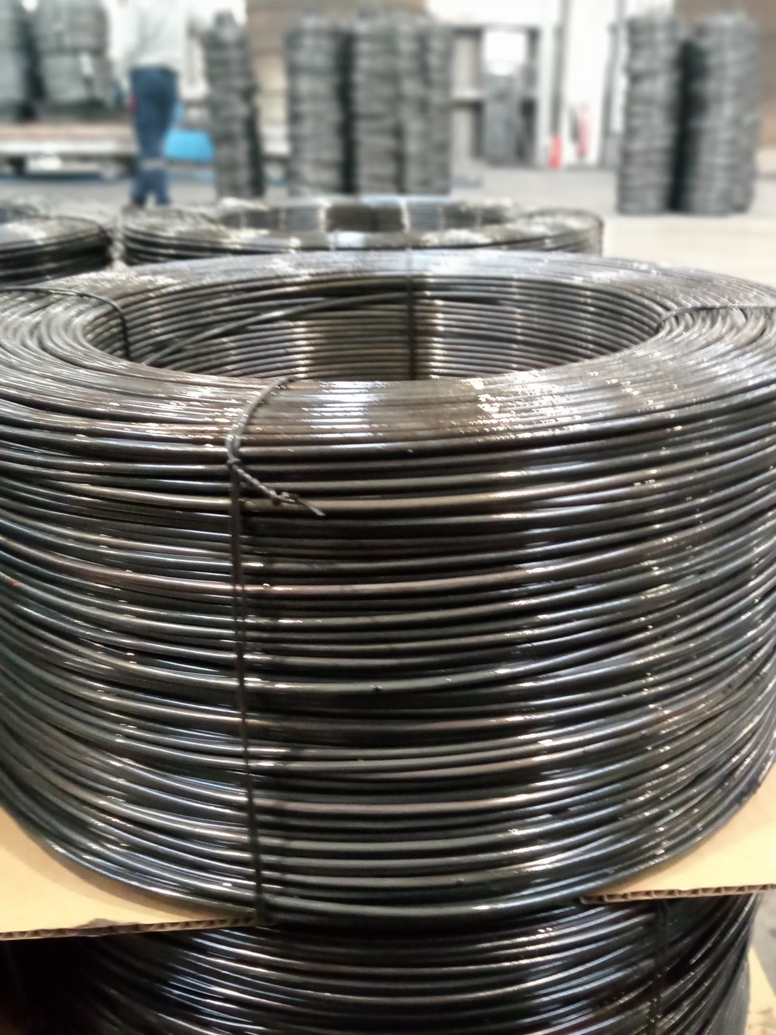 Close-up of a black annealed baling wire coil, cable-tied
