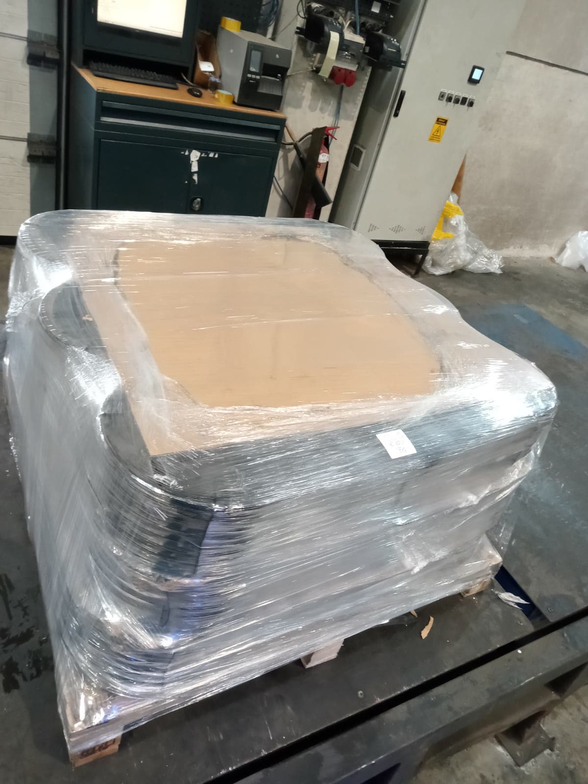 A pallet of baling wire coils shrink-wrapped and ready for shipment